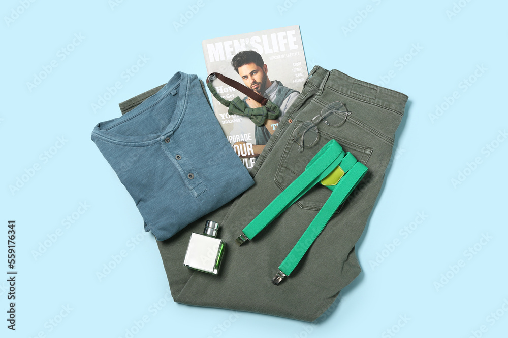 Male clothes, accessories and magazine on blue background