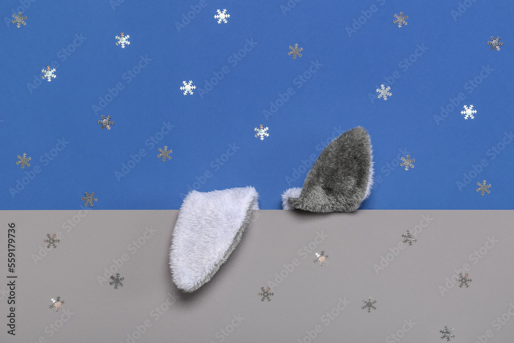 Bunny ears with snowflakes on blue and grey background