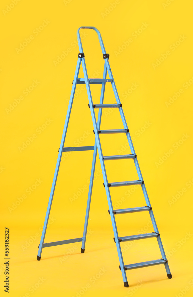 Maintenance ladder on yellow background