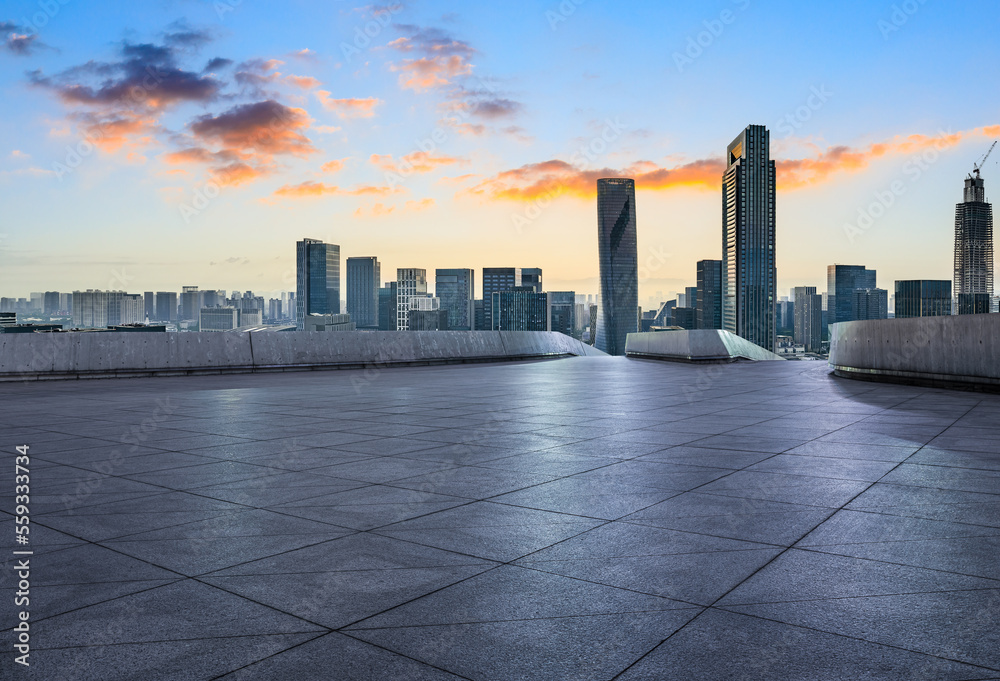 Empty square floor and modern city skyline with buildings at sunset in Ningbo, Zhejiang Province, Ch