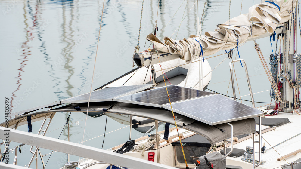 Solar photo voltaic panels on Roof top of Luxury yachts docked in sea port at sunset for Vacation.