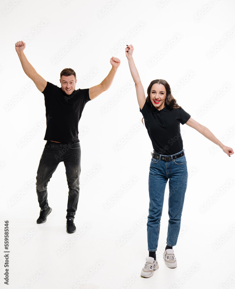 Playful couple on isolated white background. Young attractive people in casual cloth.