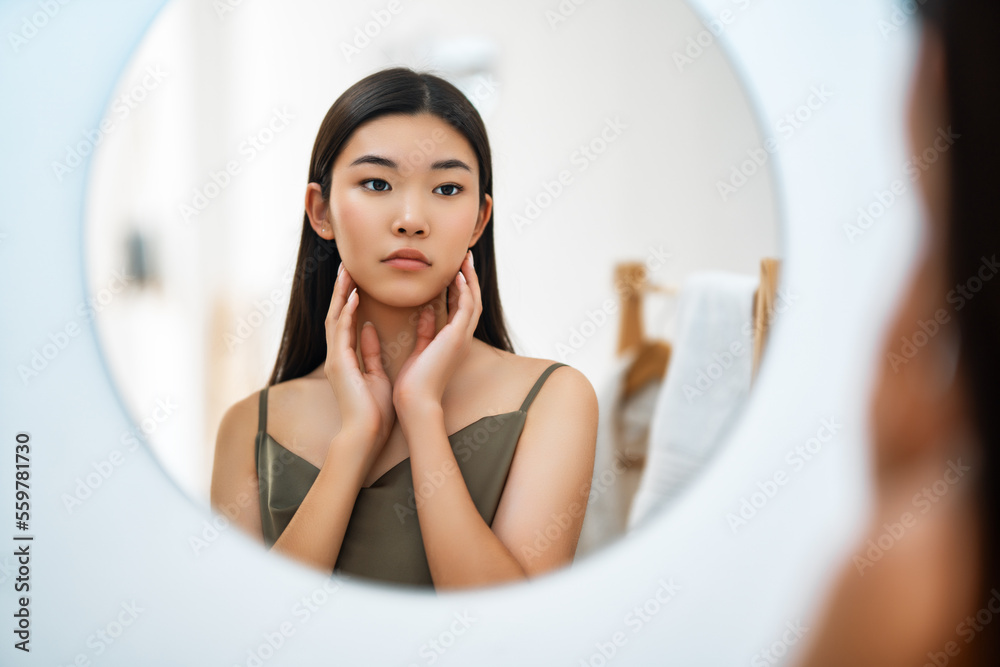 woman looking at mirror