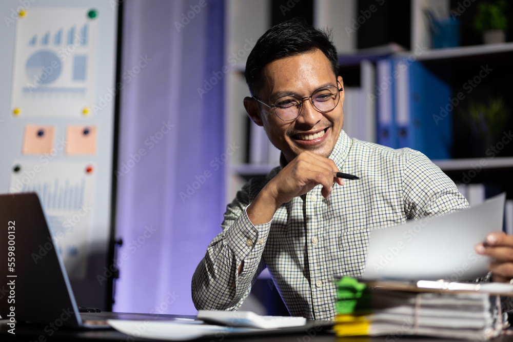 Business people working overtime at the desk in the night office.