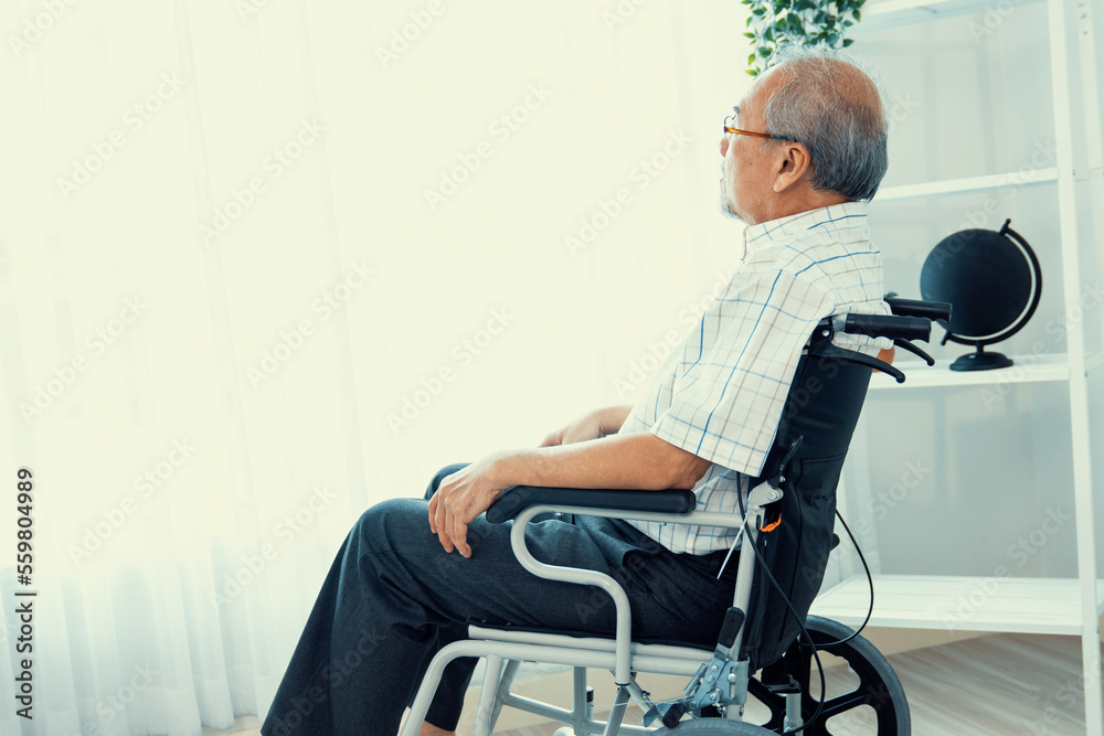 Portrait of a contented elderly man in sitting on a wheelchair at home. Senior person in nursing hou