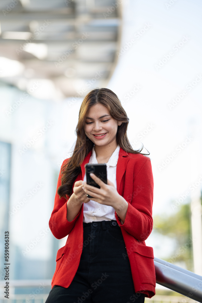 Young asian businesswoman using smart phone in office..