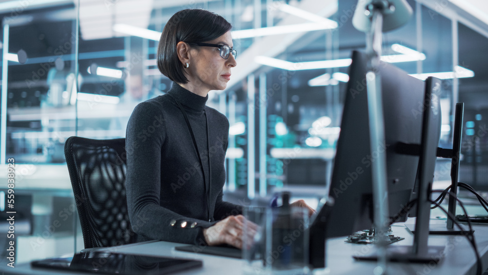 Adult Female Industrial Engineer Developing 3D Model of a Circuit Motherboard on Computer CAD Softwa