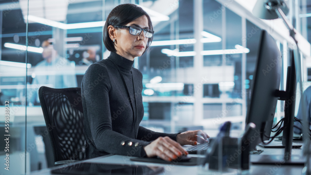 Adult Female Industrial Engineer Developing 3D Model of a Circuit Motherboard on Computer CAD Softwa