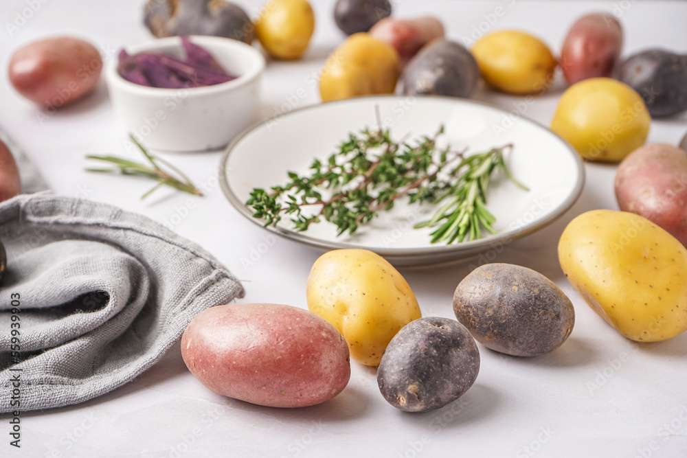 Different types of raw potatoes on light table