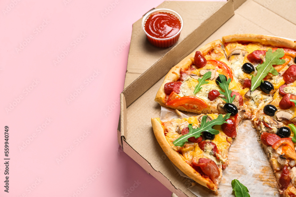 Cardboard box with tasty pizza and sauce on pink background