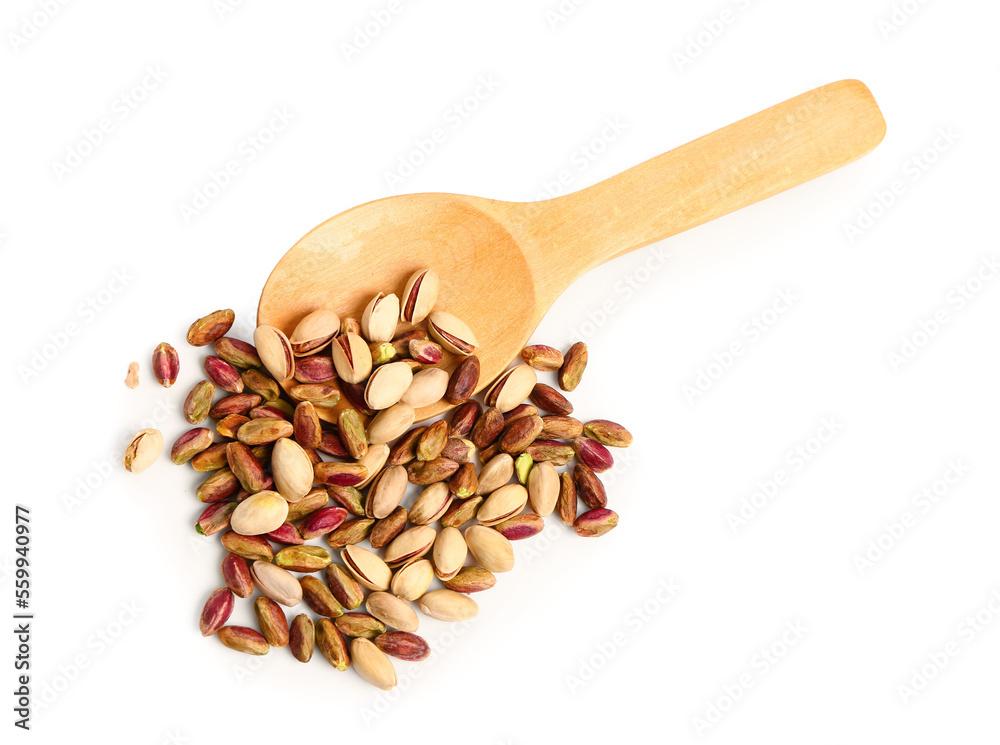 Heap of tasty pistachio nuts and wooden spoon isolated on white background