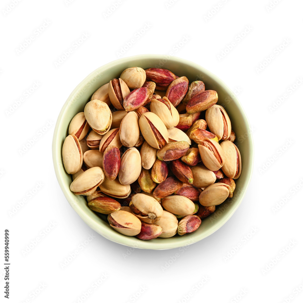 Bowl with tasty pistachio nuts isolated on white background