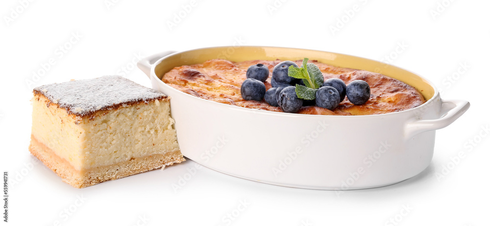 Baking form with cake and piece of delicious cheese pie isolated on white background