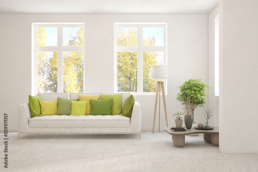 Stylish room in white color with sofa and autumn landscape in window. Scandinavian interior design. 