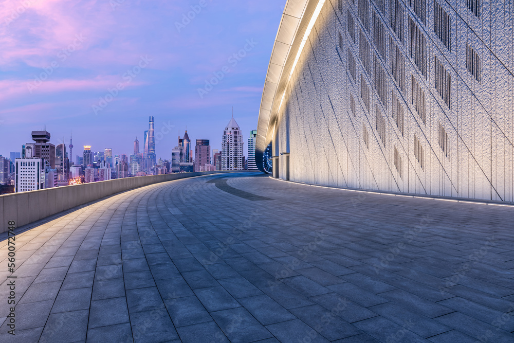 Empty square floor and wall with city skyline in Shanghai at sunset, China.