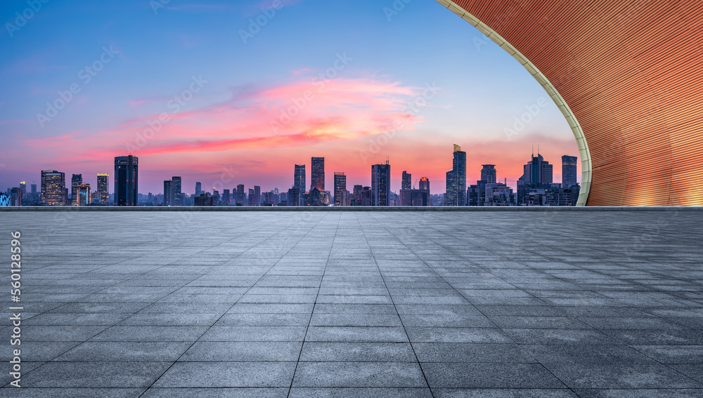 Empty square floor and city skyline with modern buildings at sunset in Shanghai, China.