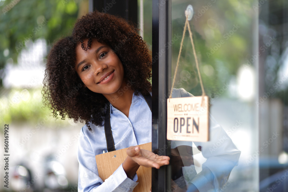 Young African woman small business start-up entrepreneur working in a cafe. Employee working in a co