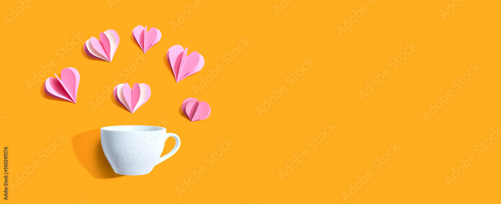 Coffee cup with paper craft hearts - flat lay