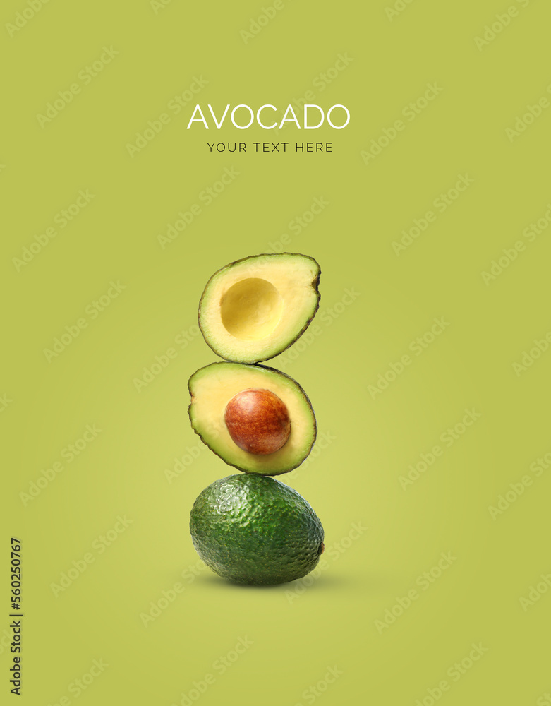 Creative layout made of avocado on the green background. Flat lay. Food concept.