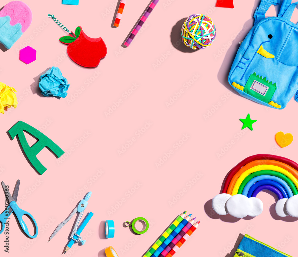 School supplies with a rainbow - overhead view - flat lay