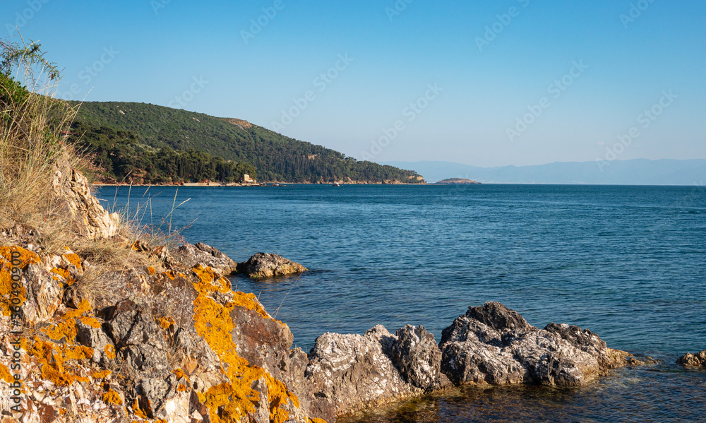 Beautiful panoramic view of the Black Sea with islands in the background. Rocky coast on a sunny sum