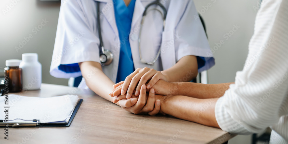 The doctor holds the patient’s. hand Healthcare and medical concept. In hospital.