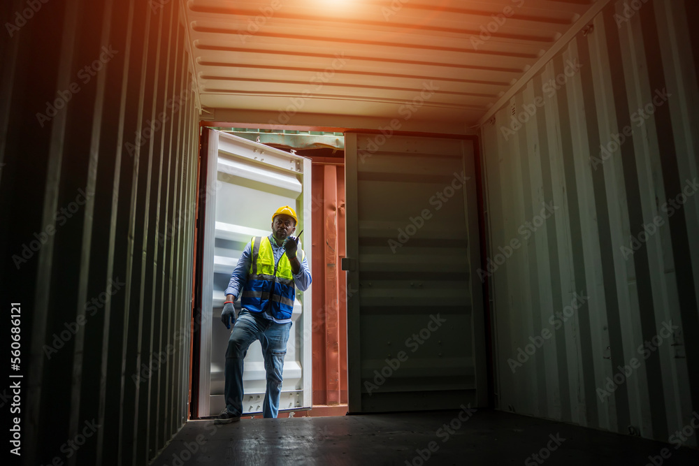 Technician working and inspecting cargo container in shipping yard,Container Shipping Logistics conc