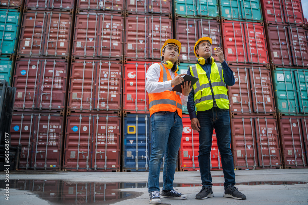 Engineer working and checking a quality of containers box from cargo ship for export and import,Cont