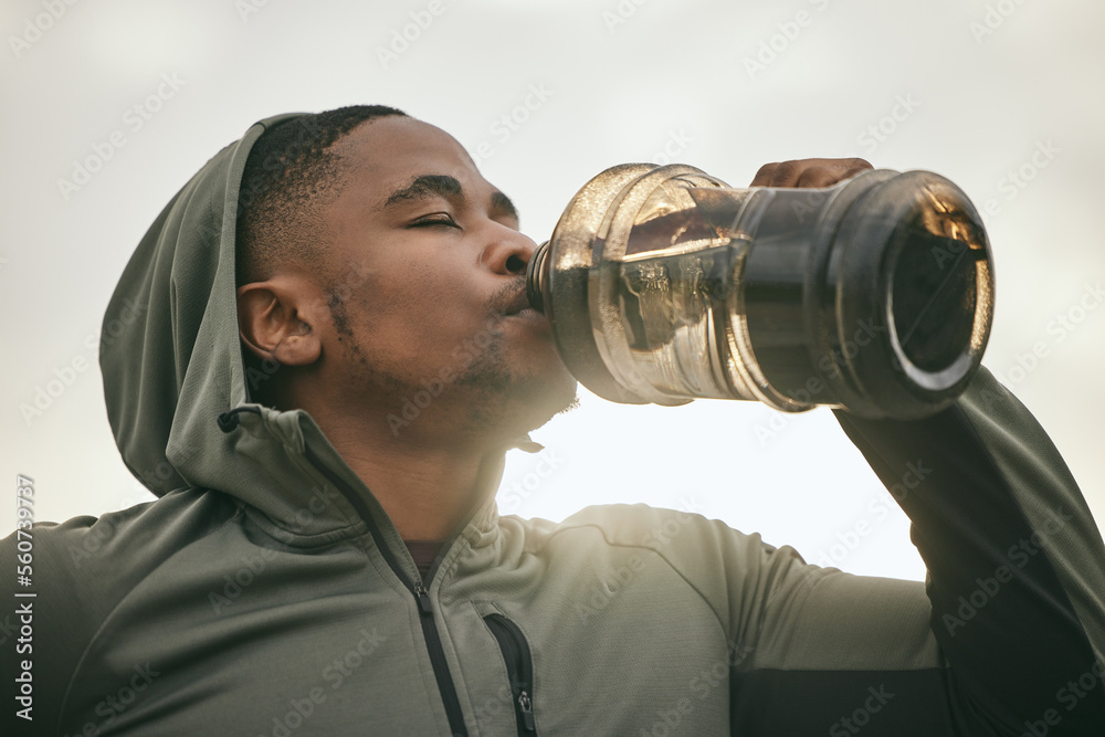 Fitness, health or black man drinking water after training, exercise or workout for body hydration. 