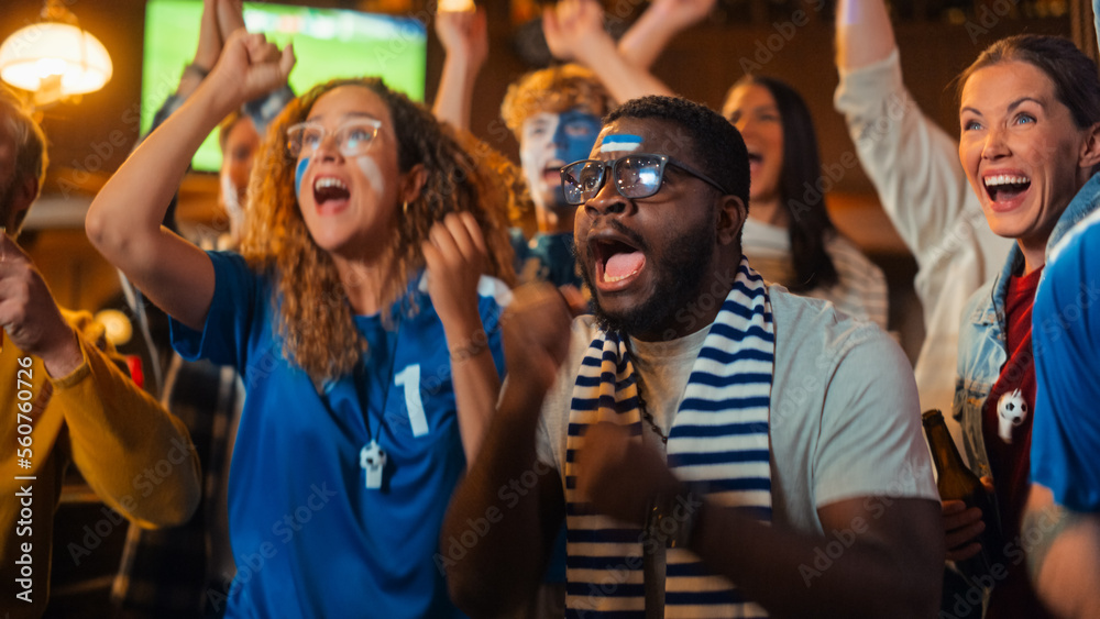 Group of Multiethnic Friends Watching a Live Soccer Match on TV in a Sports Bar. Fans with Painted F