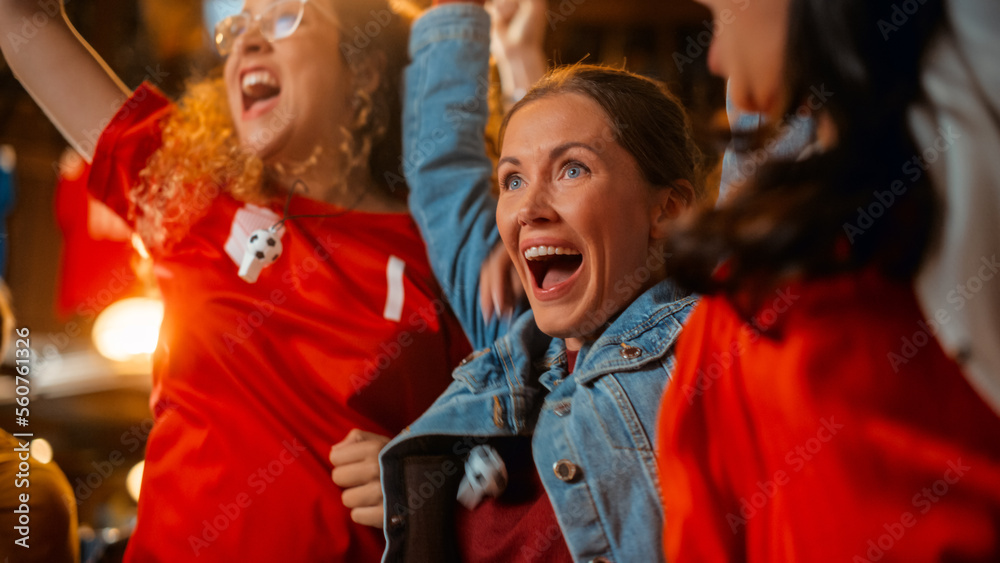 Three Female Friends Watching a Live Soccer Match on TV in a Sports Bar. Happy Girls Cheering and Sh