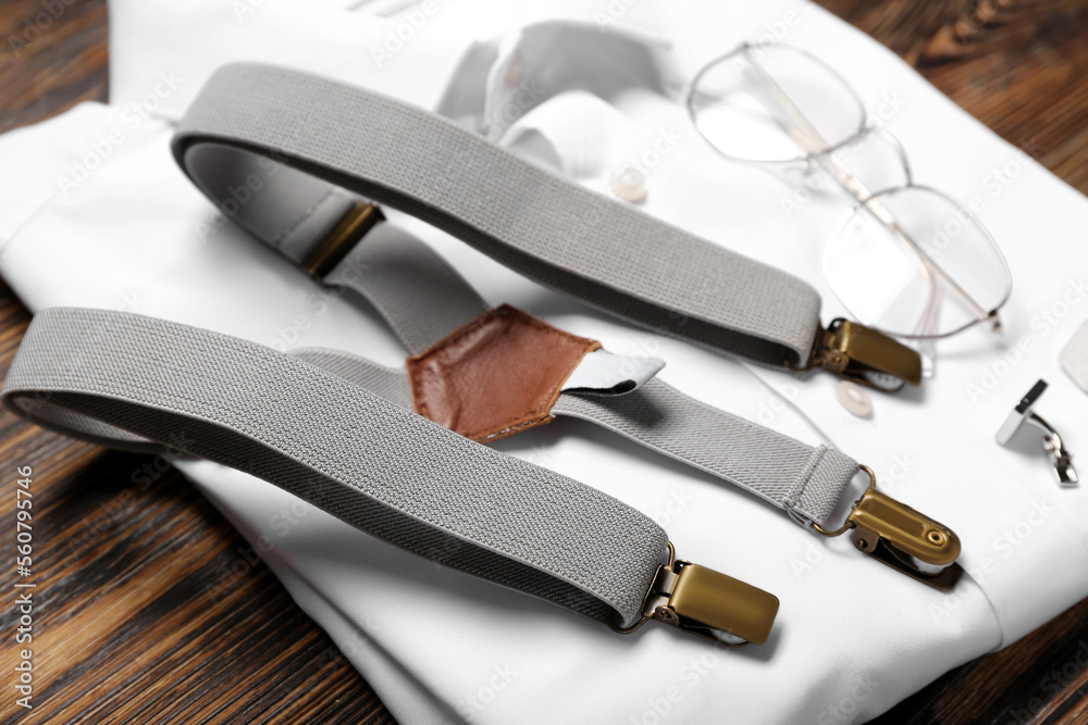 Male shirt and accessories on wooden background, closeup