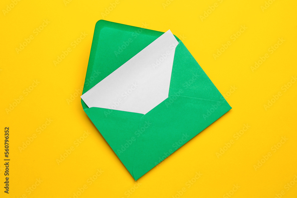 Green envelope with card on yellow background