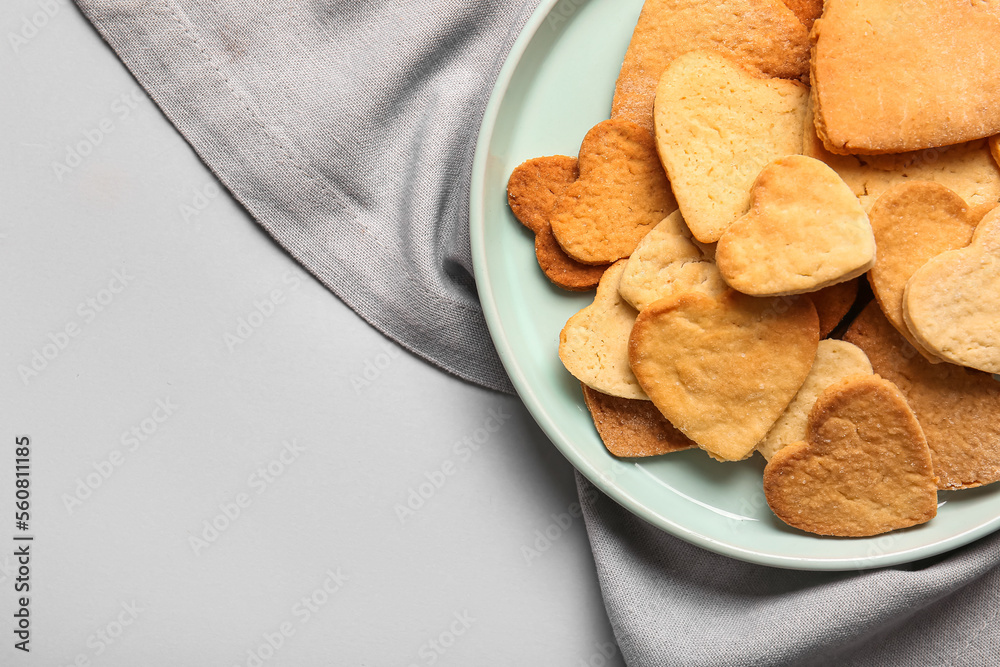 Plate with sweet heart shaped cookies on light background, closeup. Valentines Day celebration