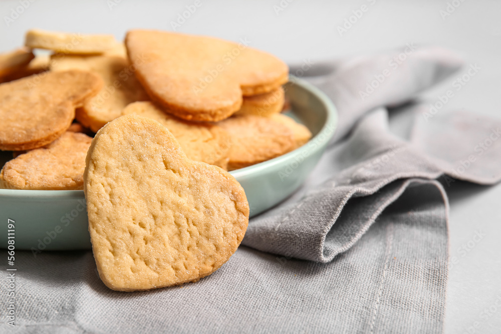 Plate of sweet heart shaped cookies on light background, closeup. Valentines Day celebration