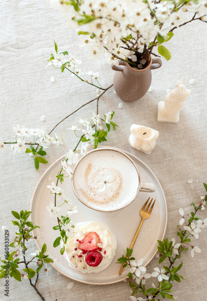 Cup with cappuccino and cake, spring flowers, morning concept, linen tablecloth, candles, womans da