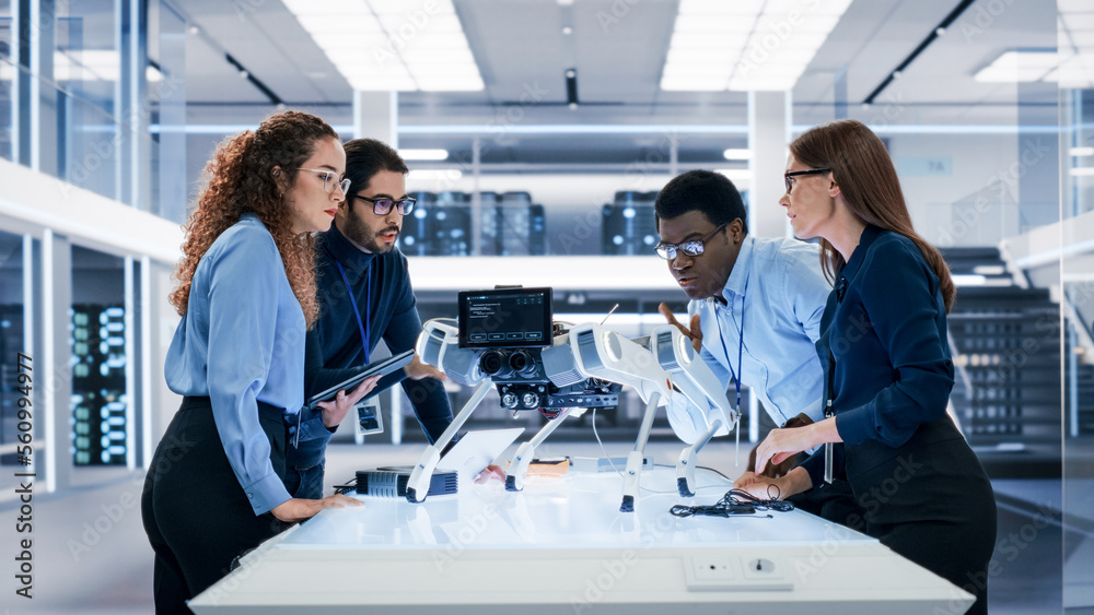 Portrait of a Young Team of Multicultural Engineers Use Computers, Insert a Circuit Board, Analyze a