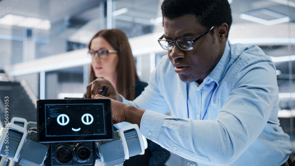 Close Up of an African Engineer Using a Screwdriver While Developing a Robot Dog Concept. Black Spec