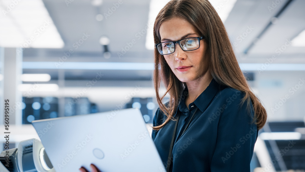 Close Up Portrait of a Young Robotics Engineer Using Laptop Computer, Analyzing Robotic Machine Conc