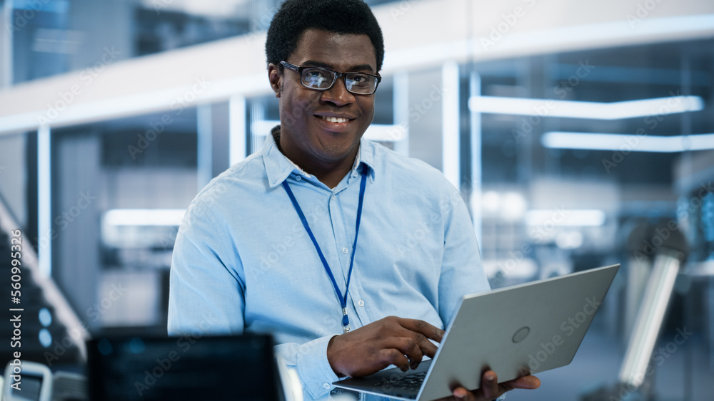 Portrait of a Handsome African Man Wearing Smart Corporate Wear and Glasses, Looking at Camera and S