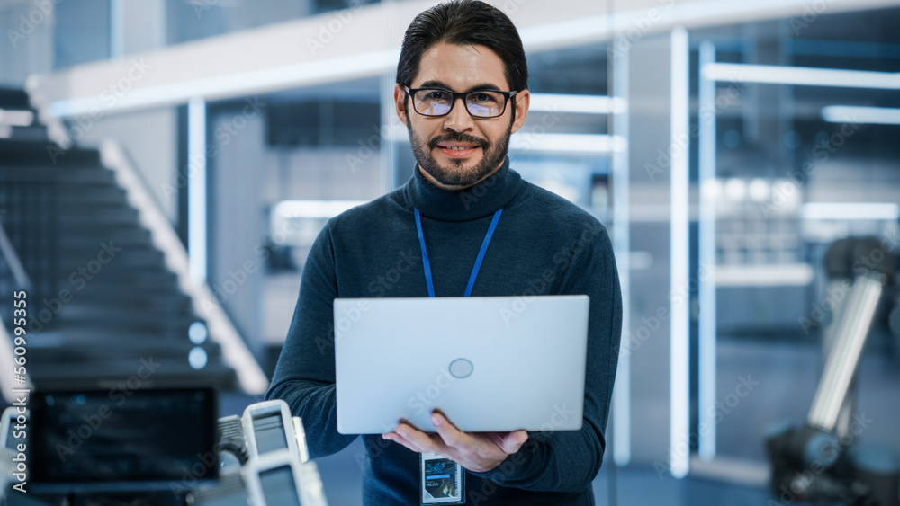 Portrait of a Professional Hispanic Man Using Laptop at Work in Research and Development Agency. You