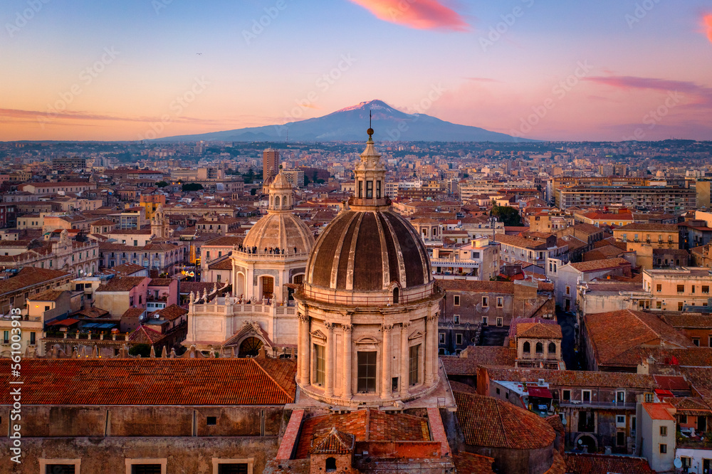 Aerial view of the Catania Saint Agathas Cathedral by sunset with Mount Etna in the background - Si