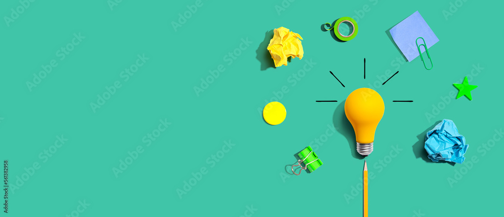 Brainstorming concept with a light bulb and school supplies