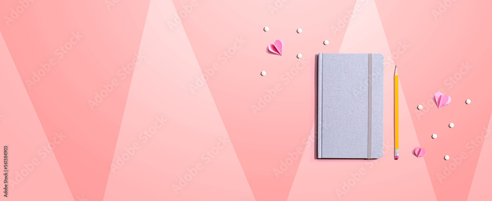 Gray notebook with paper hearts - flat lay