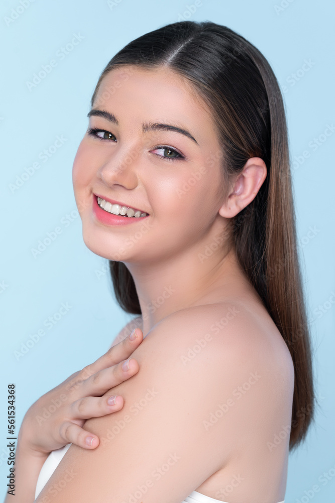 Portrait of young brunette with long hair and flawless skin with hand gesture for beauty and cosmeti