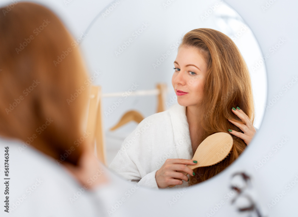 woman brushing her red hair