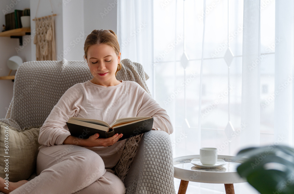 woman enjoying book and tea