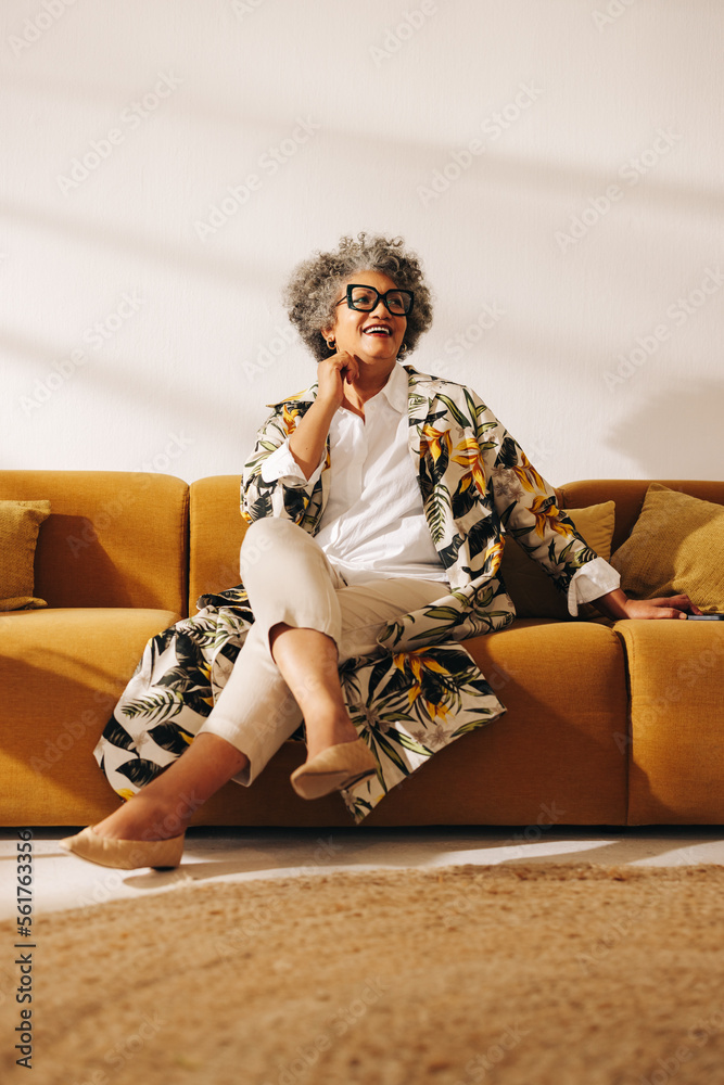 Senior businesswoman looking away with a smile in an office lobby