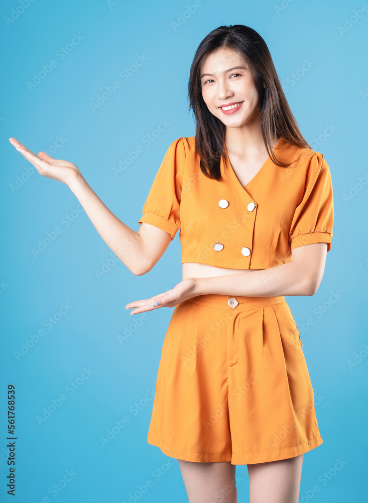 Photo of young Asian woman on blue background