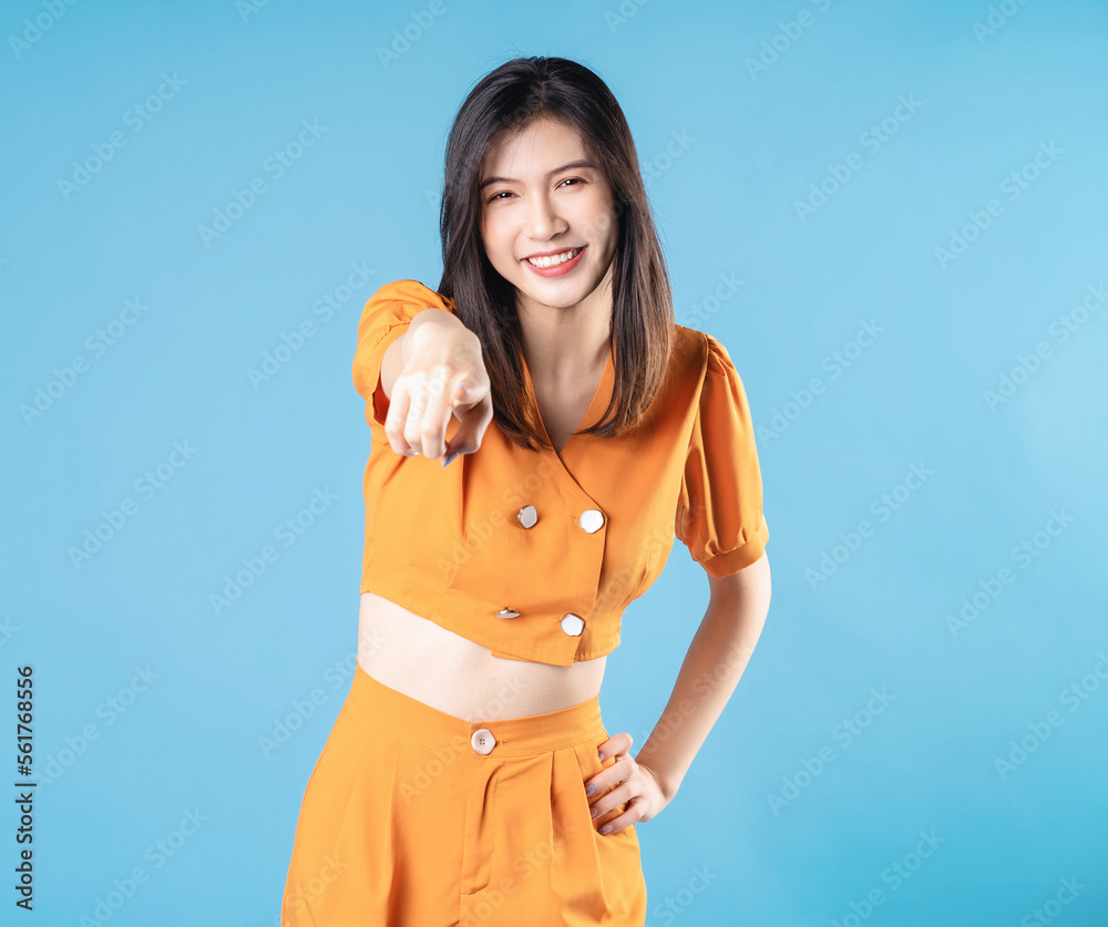 Photo of young Asian woman on blue background